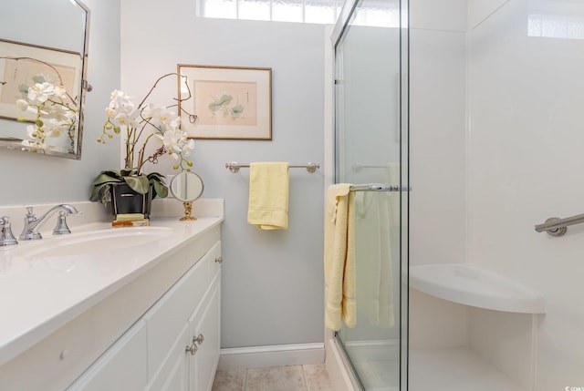 bathroom with a shower with door and vanity