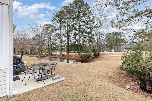 view of yard featuring a patio area and a water view