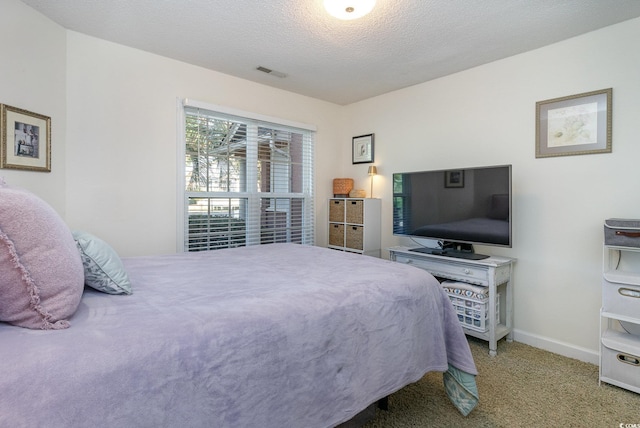 carpeted bedroom featuring a textured ceiling