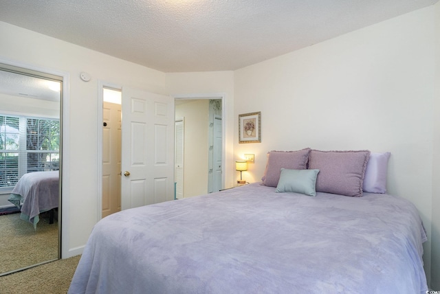 carpeted bedroom with a textured ceiling