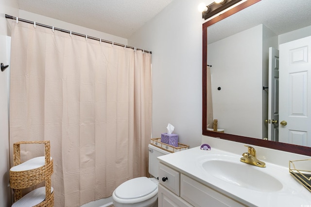 bathroom featuring vanity, toilet, and a textured ceiling