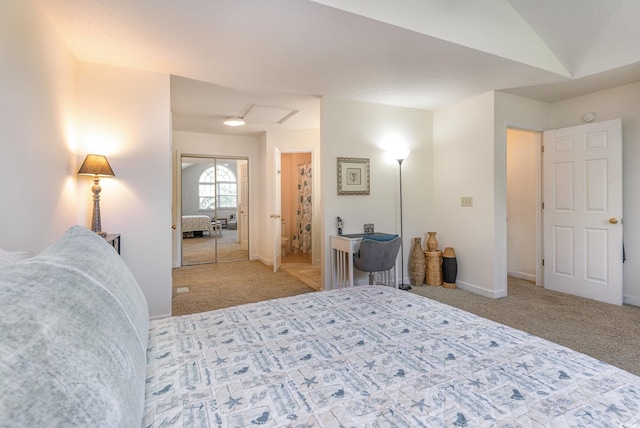 carpeted bedroom with lofted ceiling and a closet