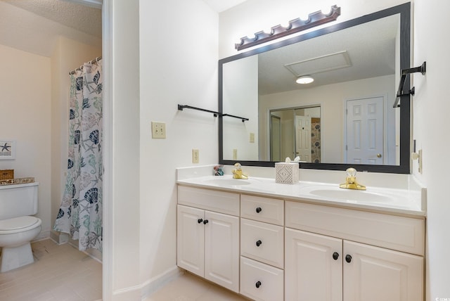 bathroom featuring a textured ceiling, vanity, tile patterned flooring, toilet, and curtained shower