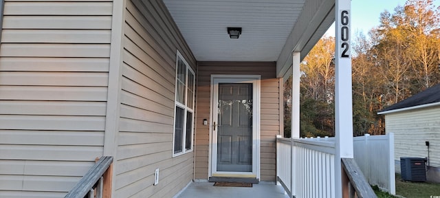 doorway to property with covered porch and cooling unit