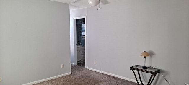 carpeted empty room with a ceiling fan and baseboards