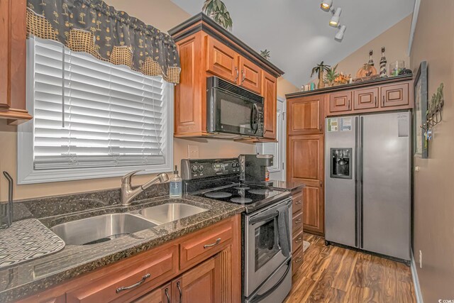 6001-1909 S Kings Hwy, Myrtle Beach, SC 29575 - kitchen featuring a sink, wood finished floors, dark stone counters, appliances with stainless steel finishes, and vaulted ceiling