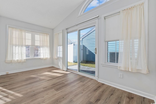 703 Gleneagles Dr, Myrtle Beach, SC 29588 - spare room with plenty of natural light, lofted ceiling, and hardwood / wood-style flooring