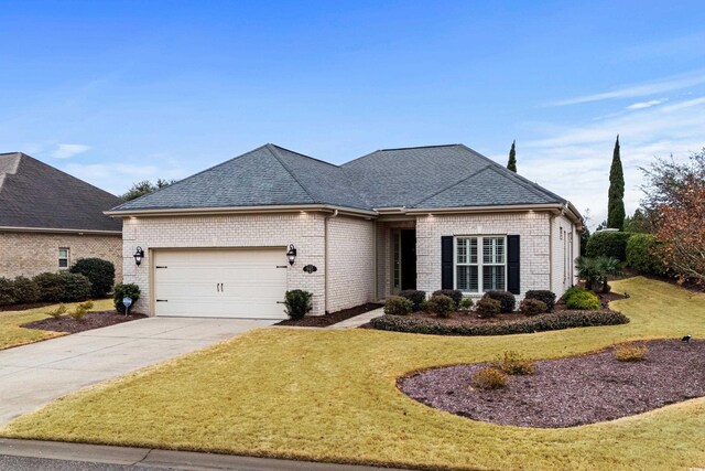 view of front of house featuring a garage and a front lawn