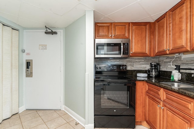 1501 S Ocean Blvd Unit 1549, Myrtle Beach, SC 29577 - kitchen featuring sink, tasteful backsplash, dark stone countertops, white refrigerator, and black / electric stove