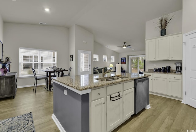 kitchen featuring white cabinetry, sink, an island with sink, and stainless steel dishwasher