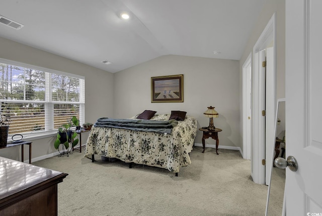 bedroom featuring light carpet and vaulted ceiling