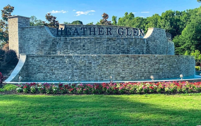 community / neighborhood sign with a yard