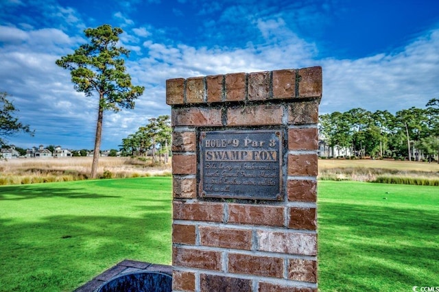 community / neighborhood sign with a lawn