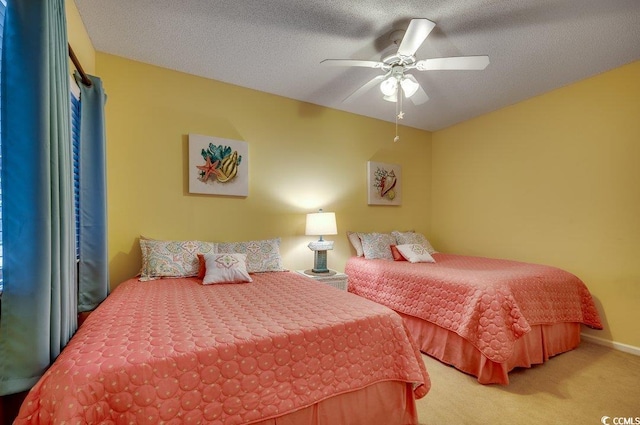 bedroom featuring a textured ceiling, carpet floors, and ceiling fan