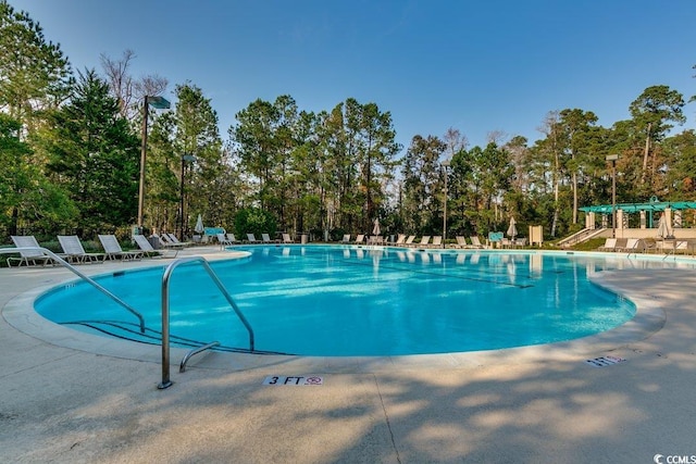 view of swimming pool featuring a pergola and a patio area