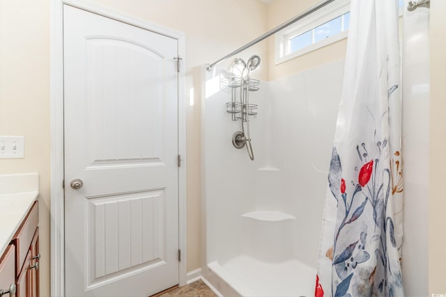 full bathroom featuring a stall shower and vanity