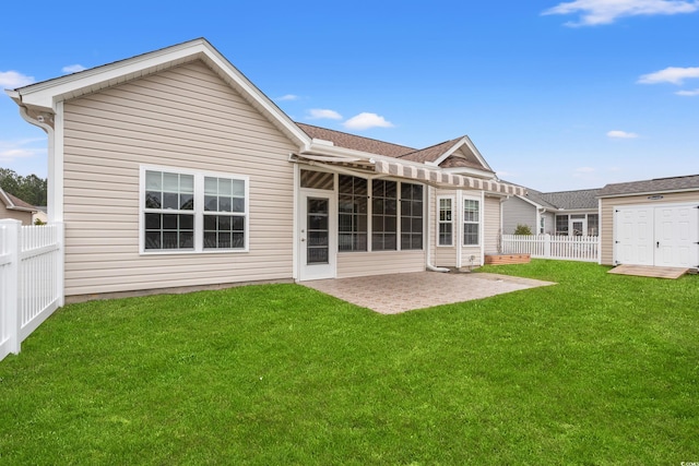 back of property featuring a fenced backyard, a lawn, and a patio