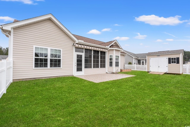 back of property featuring a patio area, a yard, and a fenced backyard