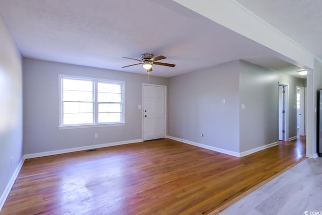 unfurnished room featuring hardwood / wood-style flooring and ceiling fan