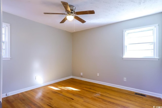 empty room featuring hardwood / wood-style floors and ceiling fan