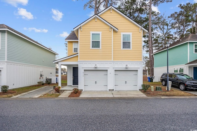 front of property with central AC unit and a garage