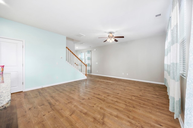 empty room featuring wood-type flooring and ceiling fan