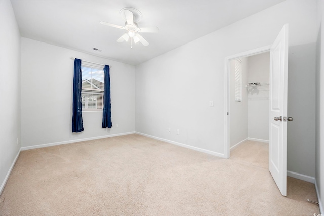 unfurnished bedroom featuring light colored carpet and ceiling fan