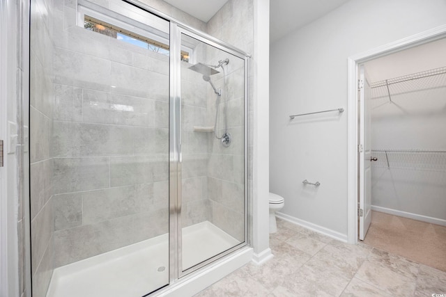 bathroom with an enclosed shower and toilet