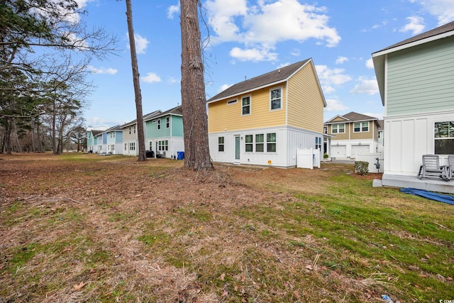 rear view of house with a yard