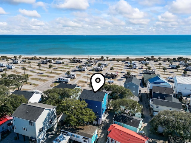 aerial view with a water view and a view of the beach