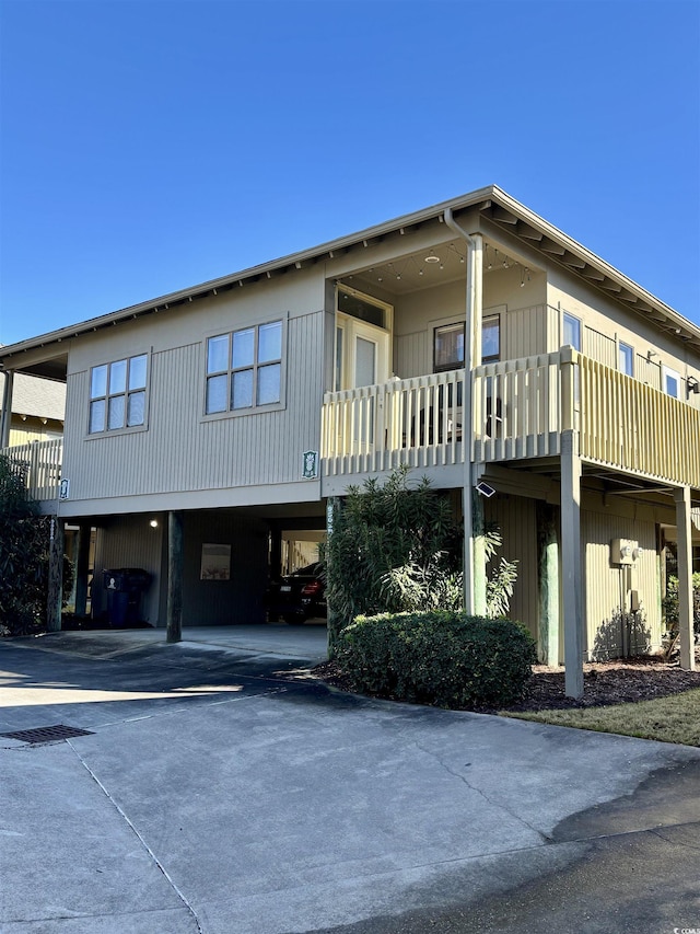 exterior space featuring a balcony and a carport