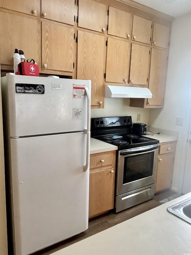 kitchen with light brown cabinets, stainless steel electric range, and white refrigerator