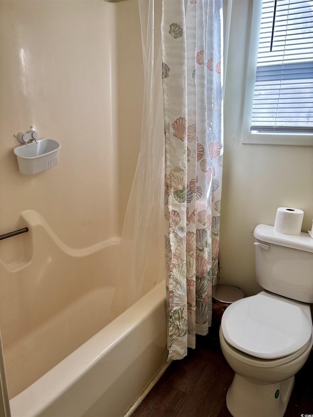 bathroom featuring shower / bathtub combination with curtain, wood-type flooring, and toilet