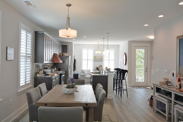 dining area featuring light hardwood / wood-style floors and a wealth of natural light