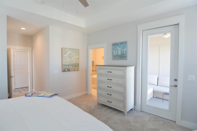 bedroom featuring ceiling fan, light colored carpet, access to outside, and ensuite bath