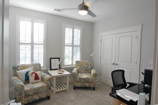 home office featuring ceiling fan and light carpet