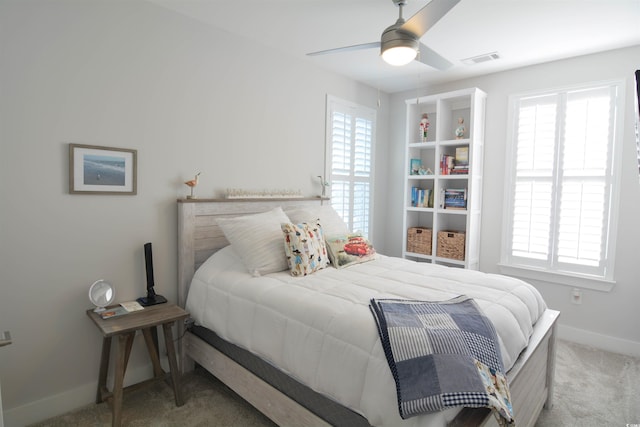 bedroom with ceiling fan and light colored carpet