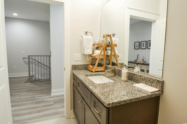 bathroom with hardwood / wood-style floors and vanity