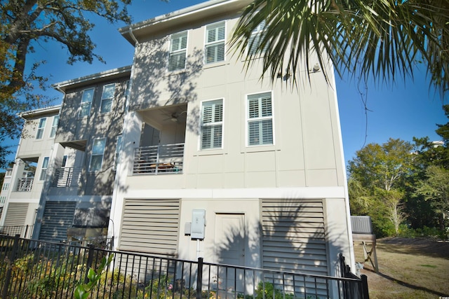 exterior space with ceiling fan and a balcony