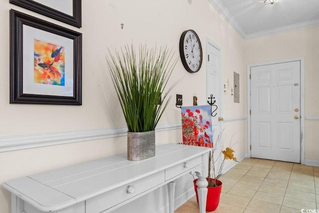 tiled foyer with electric panel and crown molding