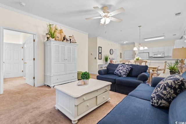 carpeted living room with crown molding and ceiling fan with notable chandelier