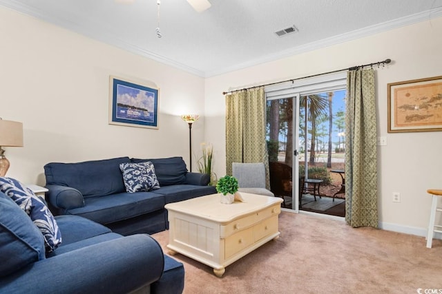 carpeted living room with ceiling fan and crown molding