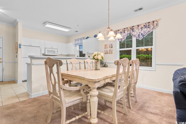 dining area with light tile patterned floors, an inviting chandelier, and crown molding