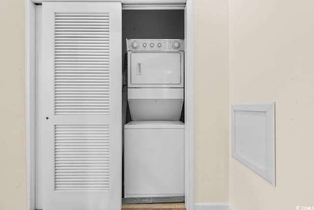 washroom featuring stacked washing maching and dryer