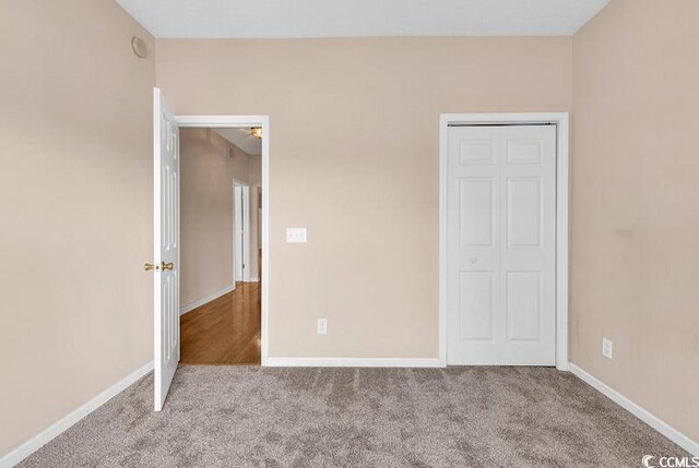 4672 Lightkeepers Way Unit 50-E, Little River, SC 29566 - unfurnished bedroom featuring baseboards, a closet, and carpet