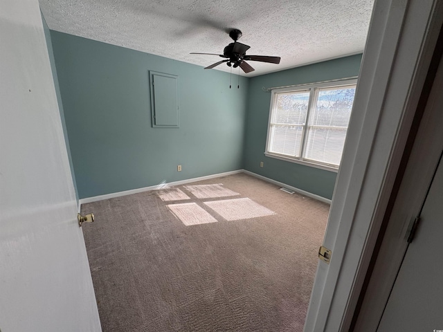 unfurnished room with light carpet, ceiling fan, and a textured ceiling