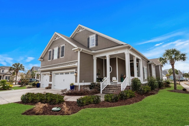 view of front of property with a porch, a garage, and a front yard