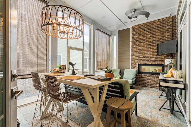 sunroom / solarium featuring a chandelier