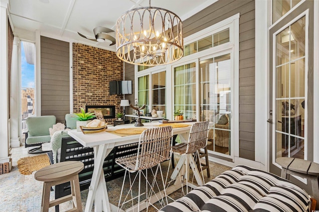 sunroom with a fireplace and a chandelier