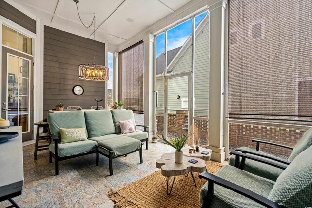 sunroom with a chandelier